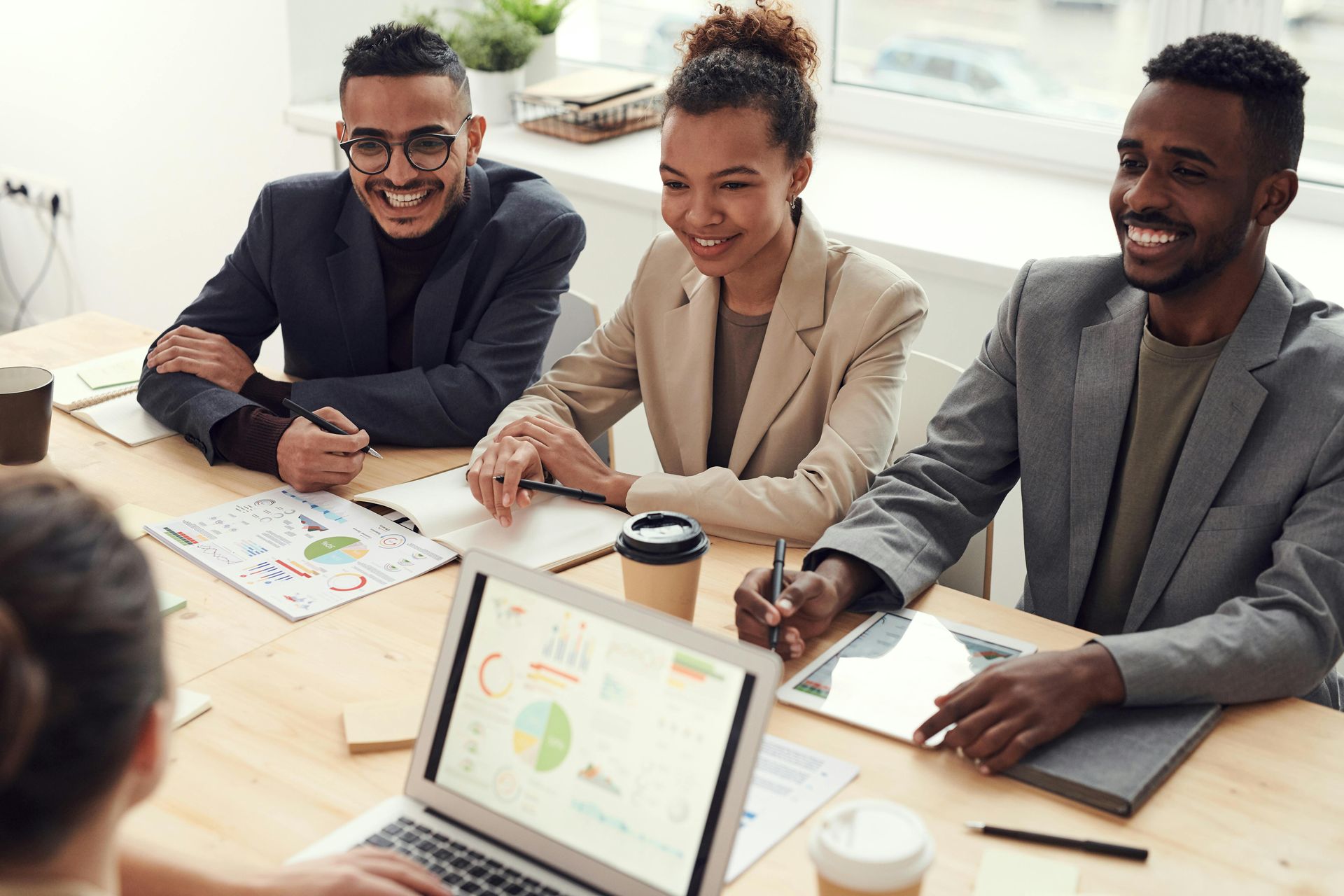 Smiling team members representing an Agency during a client meeting